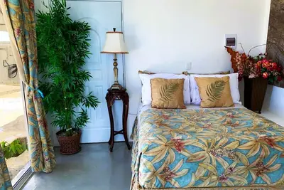Adorable tropical room with a stunning balcony, pool, fire pit, gardens, & more!