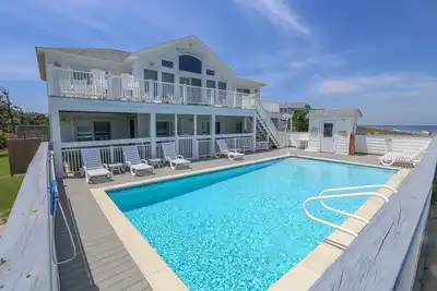 Wake up to an Outer Banks sunrise from this luxurious oceanfront home
