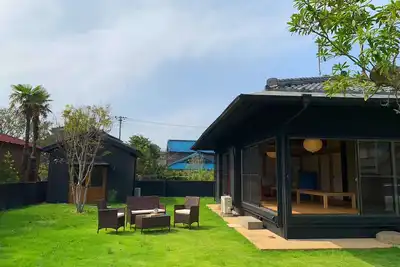 Image de A house with a large garden and a detached house.